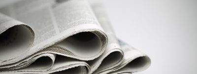 A close-up of a stack of folded newspapers