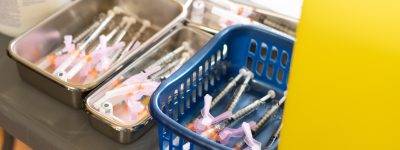 COVID-19 vaccine needles in baskets