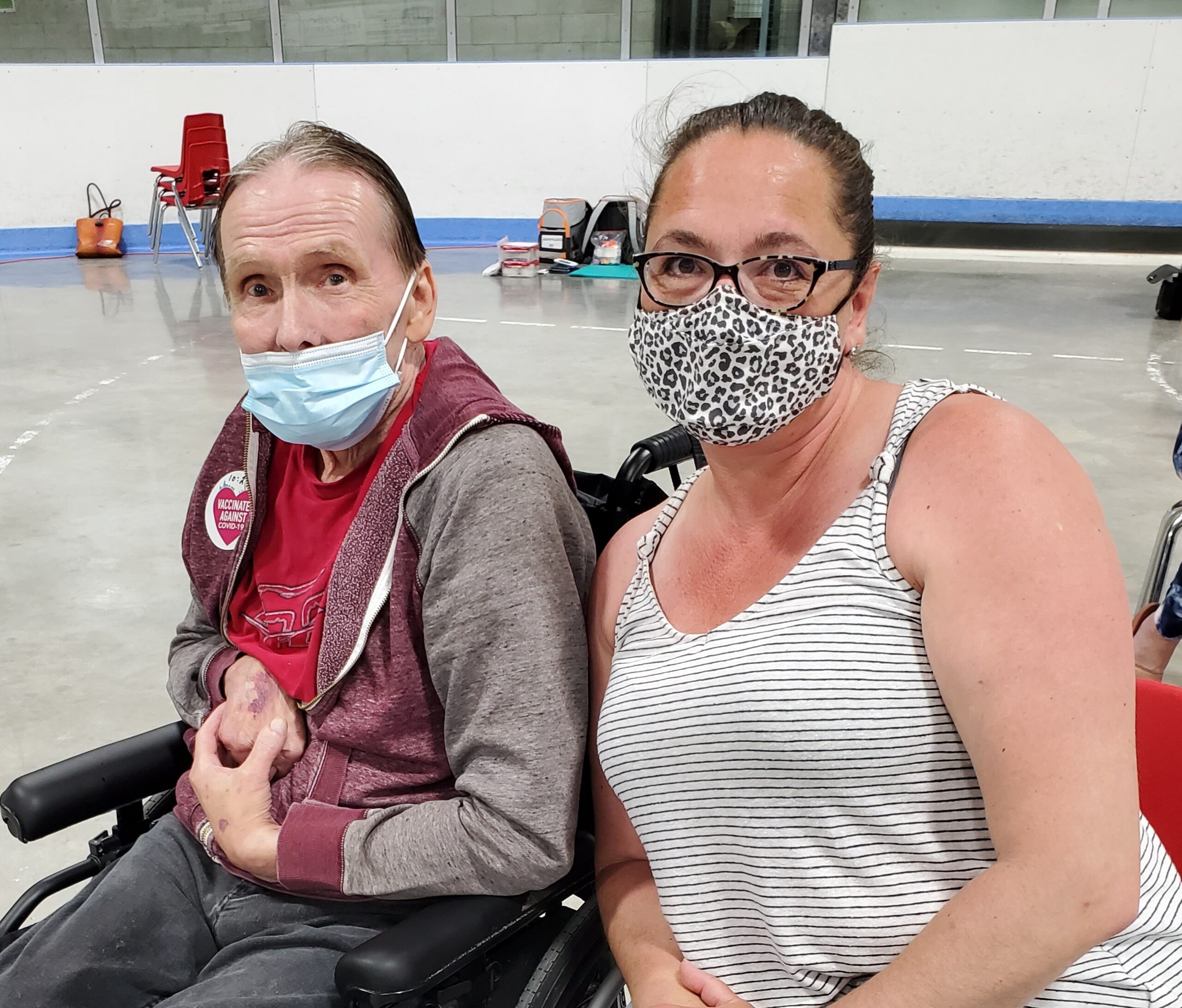 Debbie and her dad Ron sitting next to each other at the COVID vaccination clinic