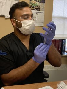 peopleCare Oakcrossing LTC RN Mazhar Muhammed prepping a COVID-19 vaccine dose