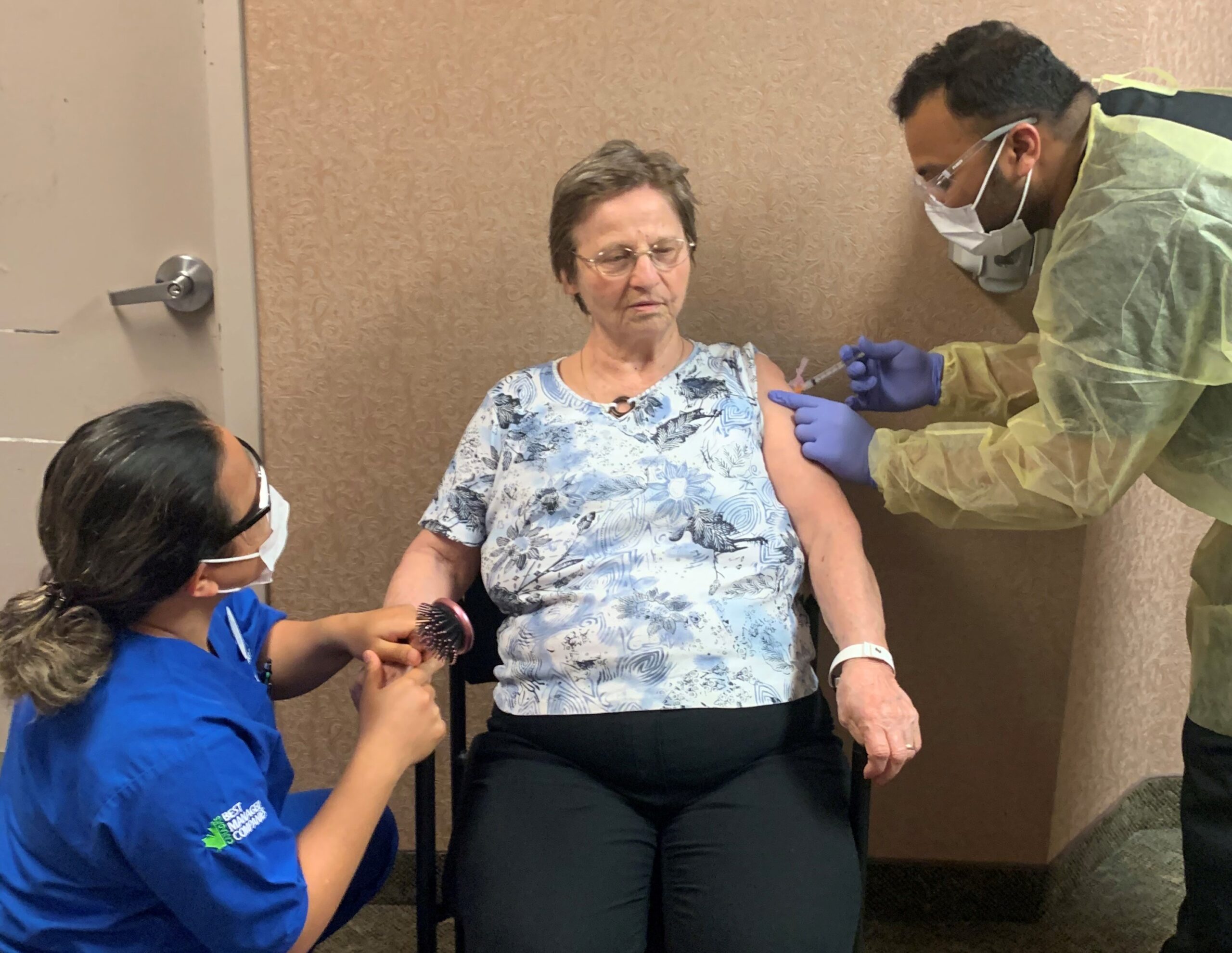 ADOC Angela Dayman and RN Mazar Muhammed give an Oakcrossing LTC resident her COVID vaccine