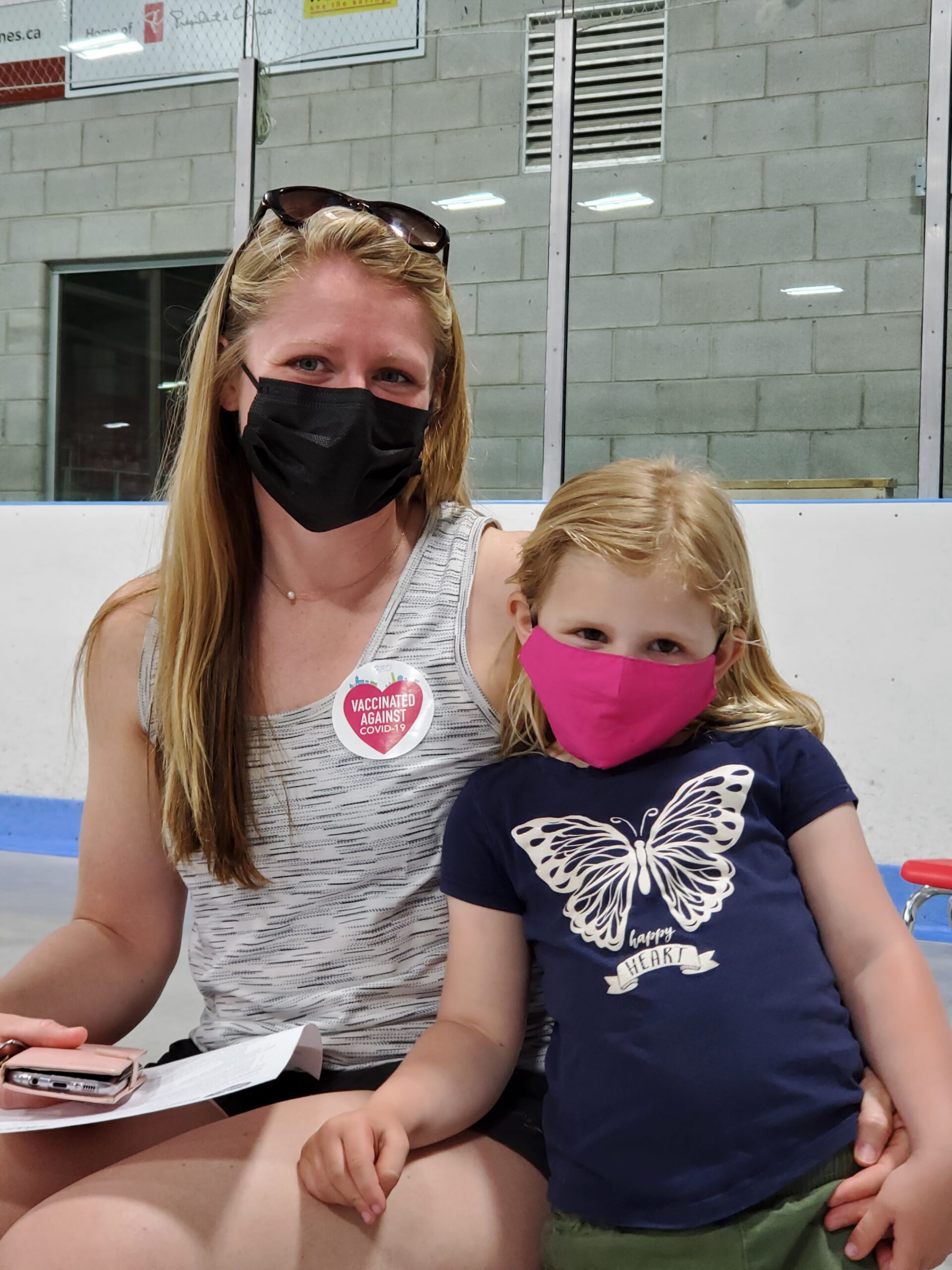 Kelly and her daughter Vaida sitting next to each other at COVID vaccination clinic