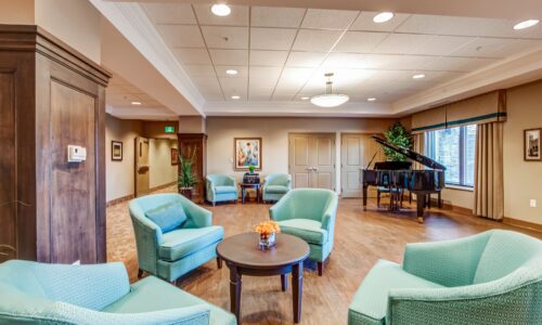 Sitting area and grand piano at Oakcrossing Retirement Living