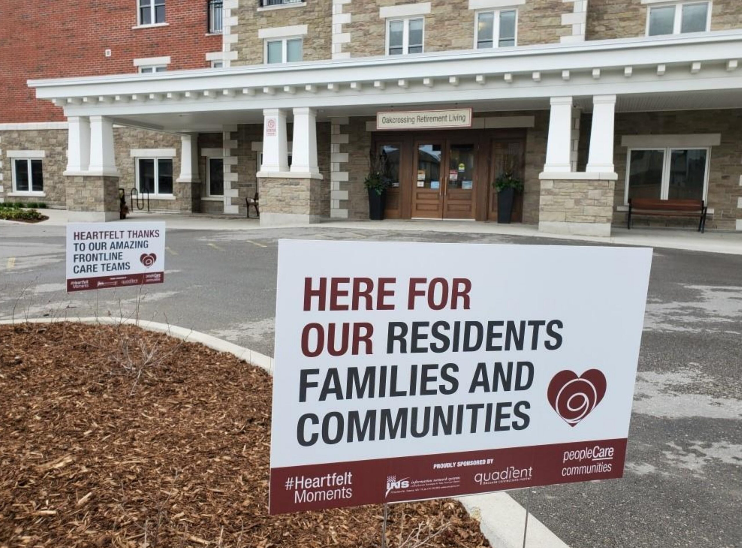 A lawn sign that says here for our residents families and communities in front of retirement home