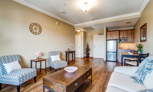 Living room area and kitchenette in suite at Oakcrossing Retirement Living