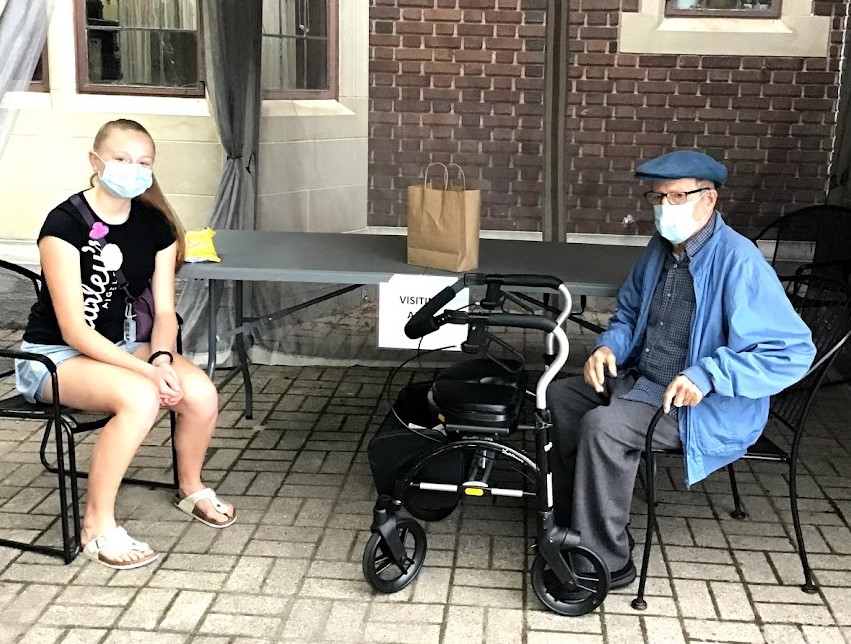 Golden Years LTC resident Adib and student during an outdoor visit at the home