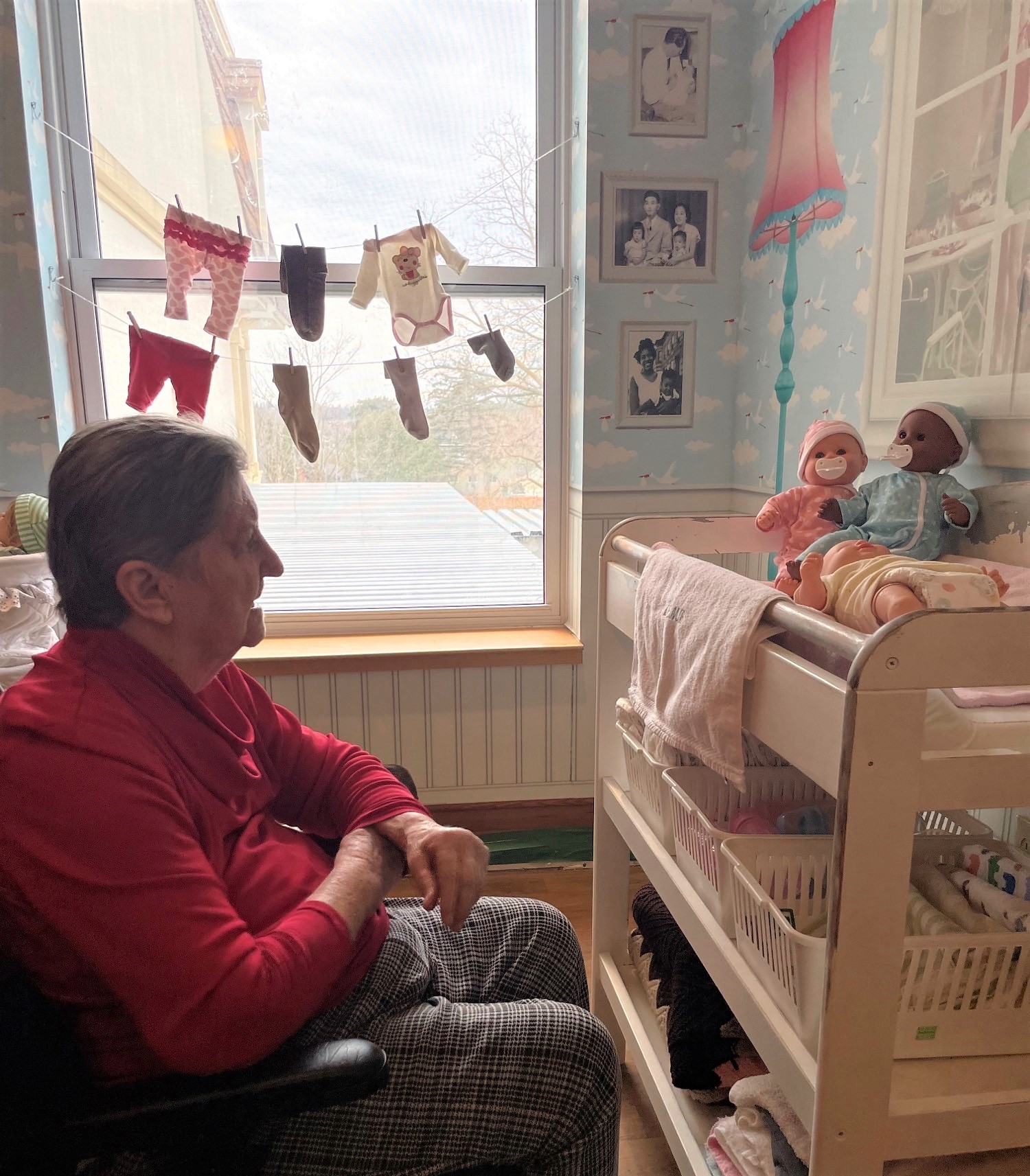 A resident enjoying the Sensory-scapes mural depicting a nursery