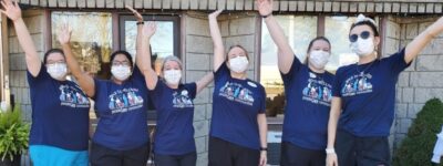 peopleCare Tavistock staff cheering in Walk to Wellness t-shirts