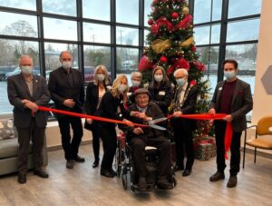 Group of people cutting a ribbon