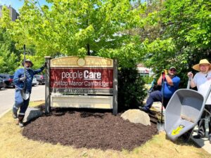 Ryan Remigis, Marc Richardson & Jason Foster pose by the peopleCare welcome sign.